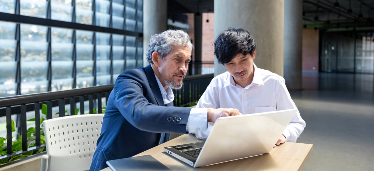 Asian senior professor is giving advice to the college student on the research thesis while sitting in the university faculty for education, academic and business concept