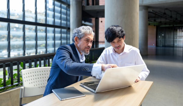 Asian senior professor is giving advice to the college student on the research thesis while sitting in the university faculty for education, academic and business concept
